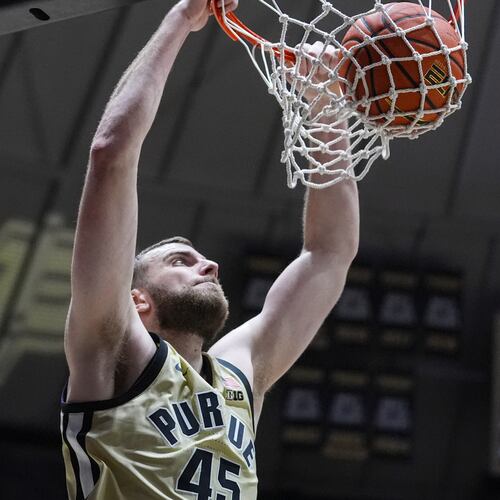 Purdue center Oscar Cluff (45) gets a basket on a dunk against Marquette during the second half of an NCAA college basketball game in West Lafayette, Ind., Saturday, Dec. 13, 2025. (AP Photo/Michael Conroy)