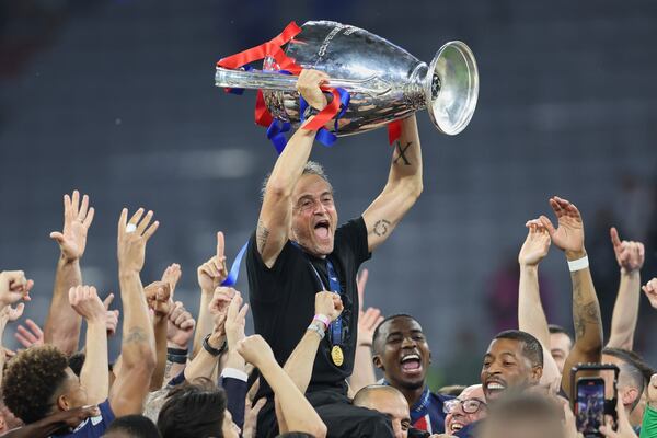PSG's head coach Luis Enrique lifts the trophy after the Champions League final soccer match between Paris Saint-Germain and Inter Milan at the Allianz Arena in Munich, Germany, Saturday, May 31, 2025. (AP Photo/Alexandra Beier)