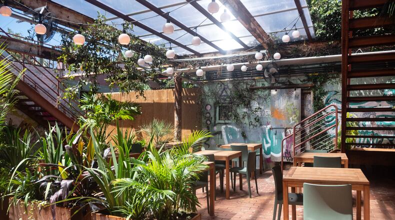 The courtyard at Lucia Pasta Bar, which will open for service later this fall. The graffiti was done over the decades when the building was in disrepair and largely open to the elements. (Bill Dawers for the AJC)