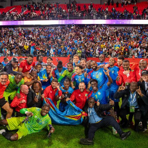 Congo national team members pose for a photo as they celebrate with their coach Sebastien Desabre after being qualified for the FIFA 2026 soccer World Cup in the African qualifier final match against Nigeria, in Rabat, Morocco, Sunday, Nov. 16, 2025. (AP Photo)