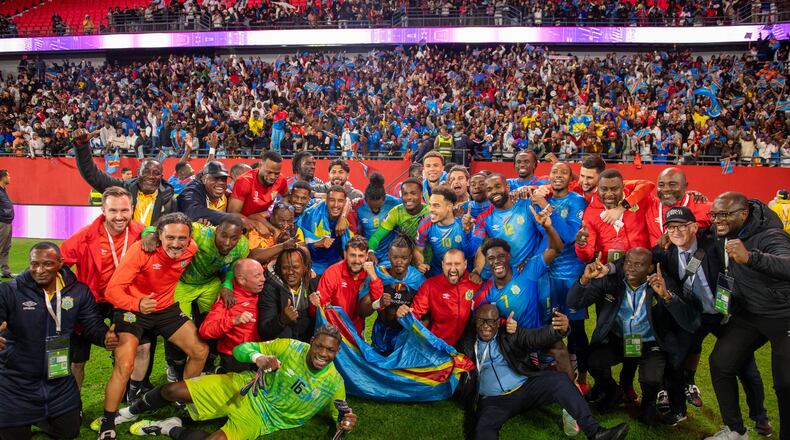 Congo national team members pose for a photo as they celebrate with their coach Sebastien Desabre after being qualified for the FIFA 2026 soccer World Cup in the African qualifier final match against Nigeria, in Rabat, Morocco, Sunday, Nov. 16, 2025. (AP Photo)