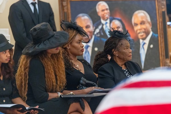 Rep. David Scott's daughters Marcye Scott (from left) and Dayna Scott Vidal, and wife Alfredia, attend the congressman's memorial in the 
Capitol rotunda May 1, 2026. Scott, with a career spanning more than 50 years in public service, died April 22 at the age of 80. (Arvin Temkar/AJC)