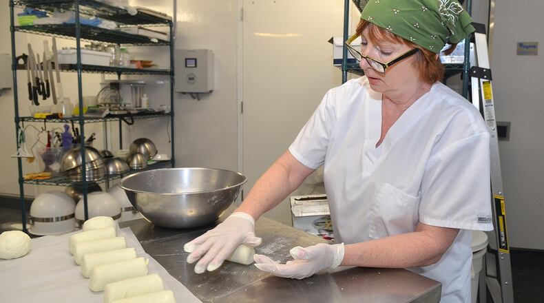 CalyRoad Creamery owner, Robin Schick forms tube shapes of cheese for the final stages before wrapping the product at the facility. (Chris Hunt/Special)