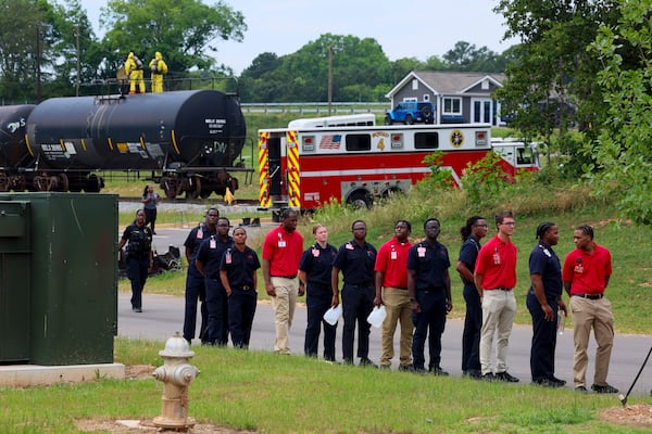 Atlanta Fire Department recruits line the road as the Atlanta Fire Department hazmat team trains on a railcar train donated by Norfolk Southern at the Atlanta Public Safety Training Center, Monday, May 11, 2026, in Atlanta, Ga. (Jason Getz/AJC)