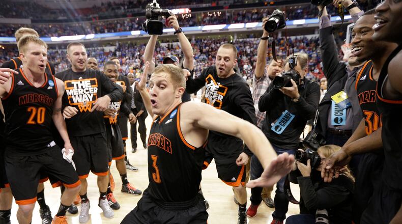 Mercer guard Kevin Canevari (3) dances with team mates after the second half of an NCAA college basketball second-round game against Duke, Friday, March 21, 2014, in Raleigh, N.C. Mercer won 78-71. (AP Photo/Chuck Burton)