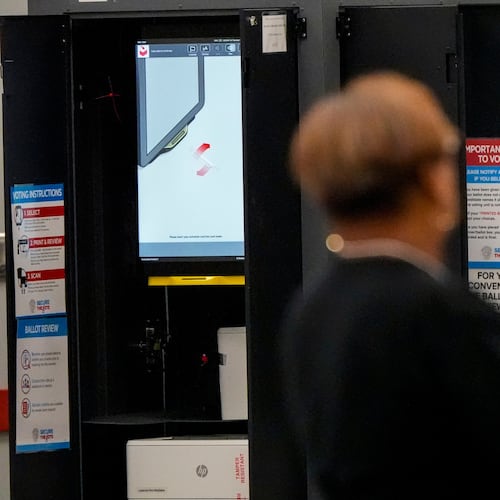 A voting machine is seen as people vote in a runoff election at the C.T. Martin Recreation Center, Tuesday, June 16, 2026, in Atlanta. (AP Photo/Mike Stewart)