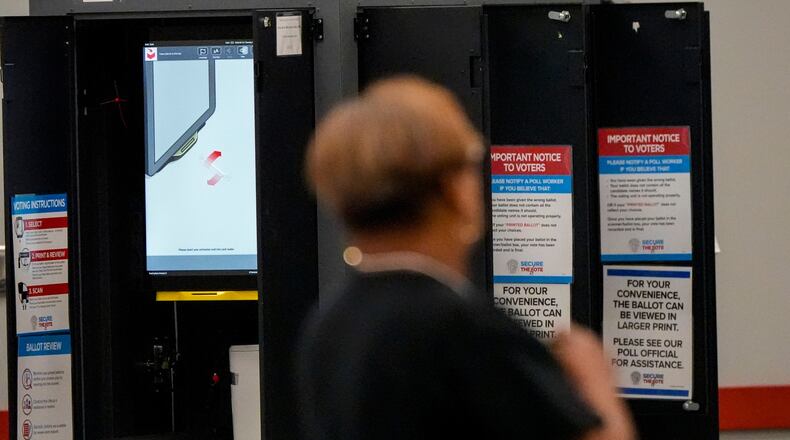 A voting machine is seen as people vote in a runoff election at the C.T. Martin Recreation Center, Tuesday, June 16, 2026, in Atlanta. (AP Photo/Mike Stewart)
