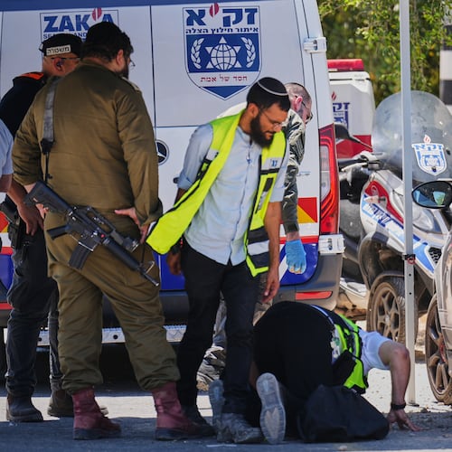 Israeli security forces and ZAKA rescue service volunteers respond at the scene of a shooting attack carried out by a Palestinian citizen of Israel near Tzur Yitzhak in central Israel, Sunday, June 7, 2026. (AP Photo/Ariel Schalit)