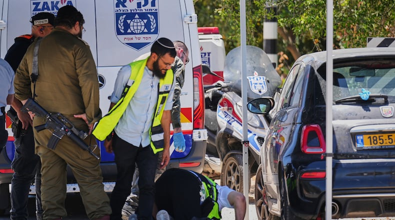 Israeli security forces and ZAKA rescue service volunteers respond at the scene of a shooting attack carried out by a Palestinian citizen of Israel near Tzur Yitzhak in central Israel, Sunday, June 7, 2026. (AP Photo/Ariel Schalit)