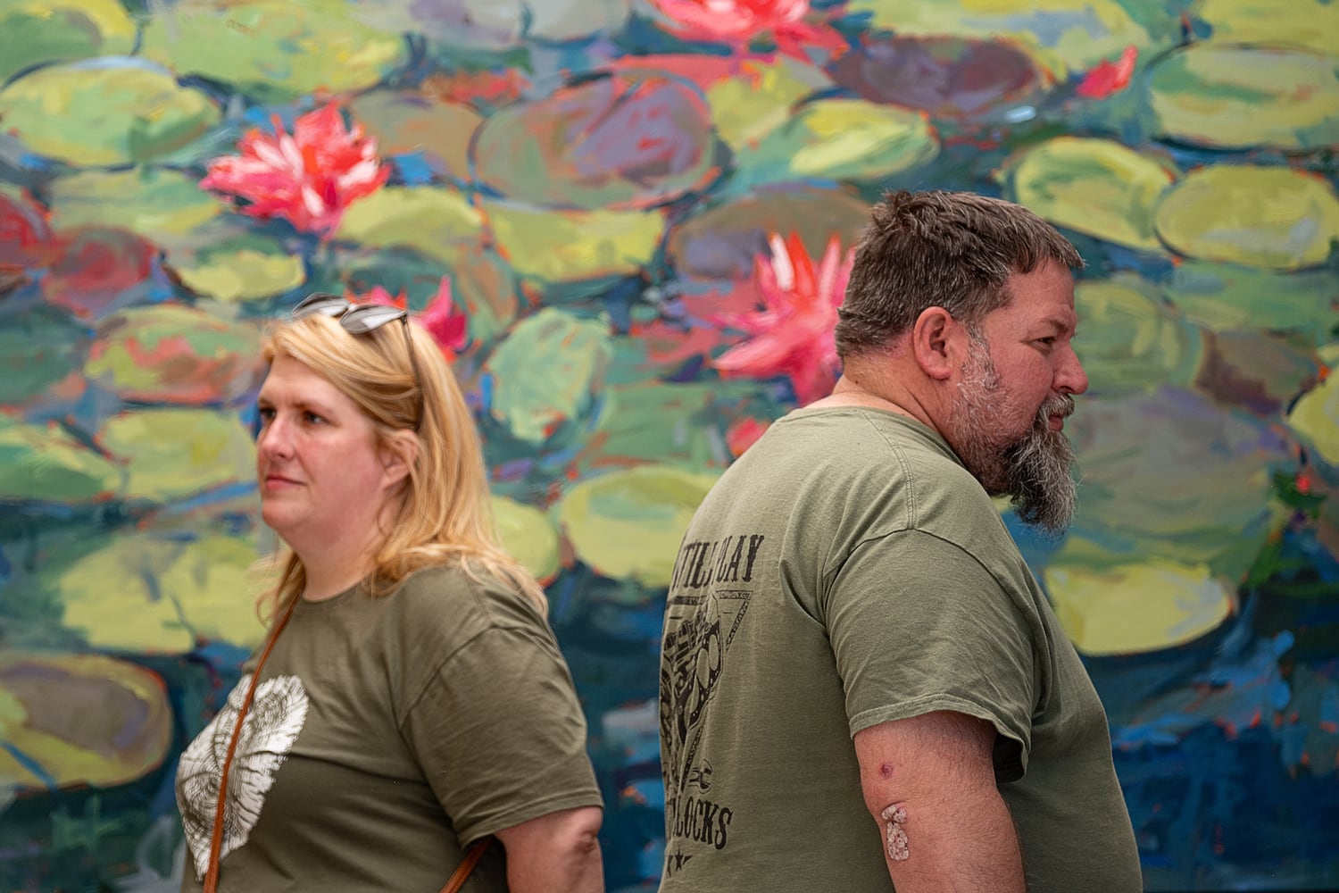 Susan Miller and Pete March look at oil paintings in Larry Smith’s booth at the Atlanta Dogwood Festival at Piedmont Park on Saturday, April 11, 2026. (Ben Gray for the AJC)