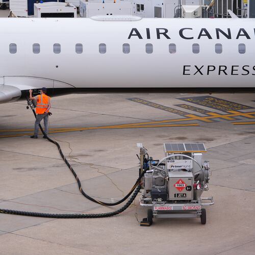 FILE - A worker fuels an Air Canada jet at DFW International Airport in Grapevine, Texas, Tuesday, April 14, 2026. (AP Photo/LM Otero, File)