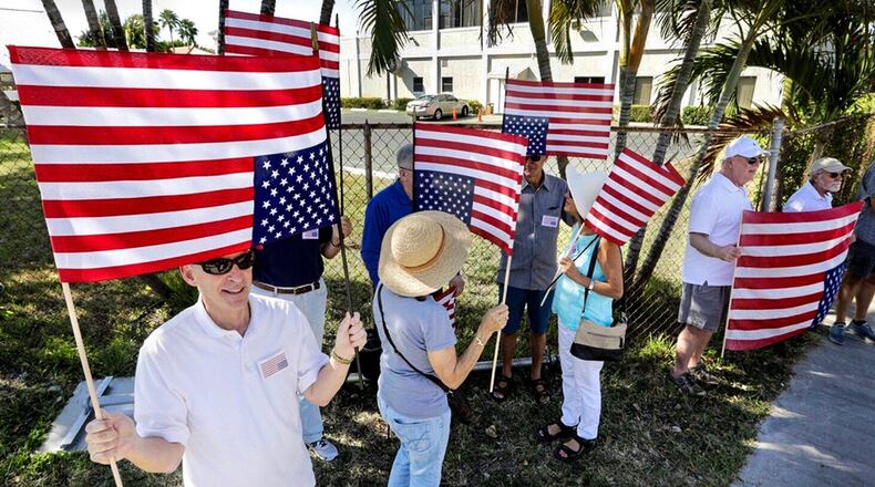 About two dozen people gathered on Southern Boulevard in West Palm Beach, Fla., less than a mile from Mar-a-Lago, the winter white house for Donald Trump following a protest of President Trump’s inauguration Friday, January 20, 2017. (Lannis Waters / The Palm Beach Post)