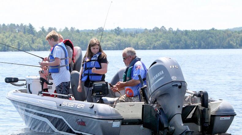 Lake Vermilion guide Mike Estrin lands a walleye during Wednesday's Take a Kid Fishing Day. Some 100 kids spent an afternoon on Lake Vermilion with 45 local fisherman. (John Myers/Duluth News Tribune/TNS)