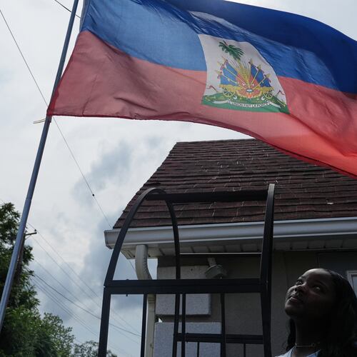 Patricia Grace Louis-Jacques, a nursing student who has close Haitian family members and friends affected by the end of TPS, poses for a photo outside the Caribbean Creole Café in Salisbury, Md., Sunday, Aug. 2, 2026. (AP Photo/Luis Andres Henao)