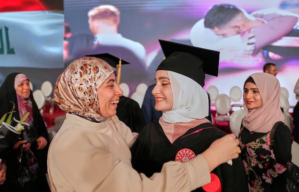 An Iraqi mother celebrates with her daughter during the first graduation for The American University of Iraq - Baghdad students in Baghdad, Iraq, Saturday, May 24, 2025. (AP Photo/Hadi Mizban)
