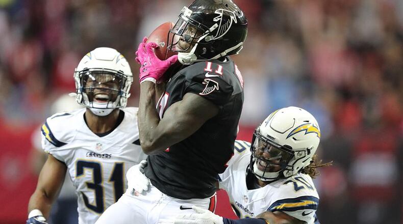 October 23, 2016 Atlanta: Falcons wide receiver Julio Jones hauls in a long reception from Matt Ryan between Chargers defenders Adrian Phillips (left) and Dwight Lowery during the second quarter in an NFL football game on Sunday, Oct. 23, 2016, in Atlanta. Curtis Compton /ccompton@ajc.com