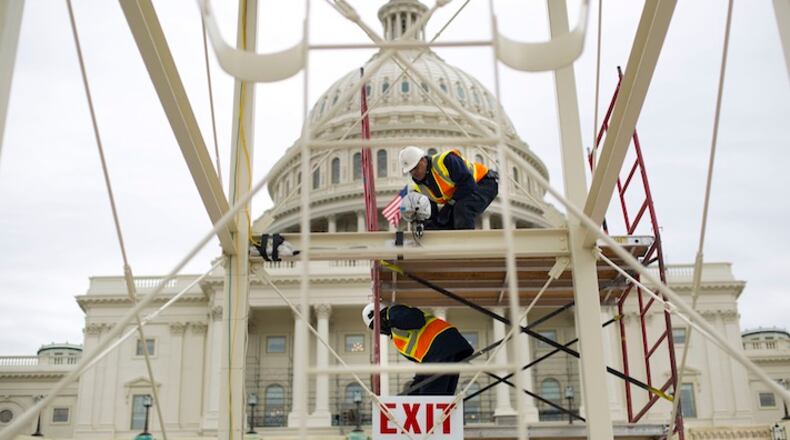 Construction continues on the Inaugural platform in preparation for the Inauguration and swearing-in ceremonies for President-elect Donald Trump, Thursday, Dec. 8, 2016, on the Capitol steps in Washington.Trump will be sworn in a president on Jan. 20, 2017. (AP Photo/Pablo Martinez Monsivais)