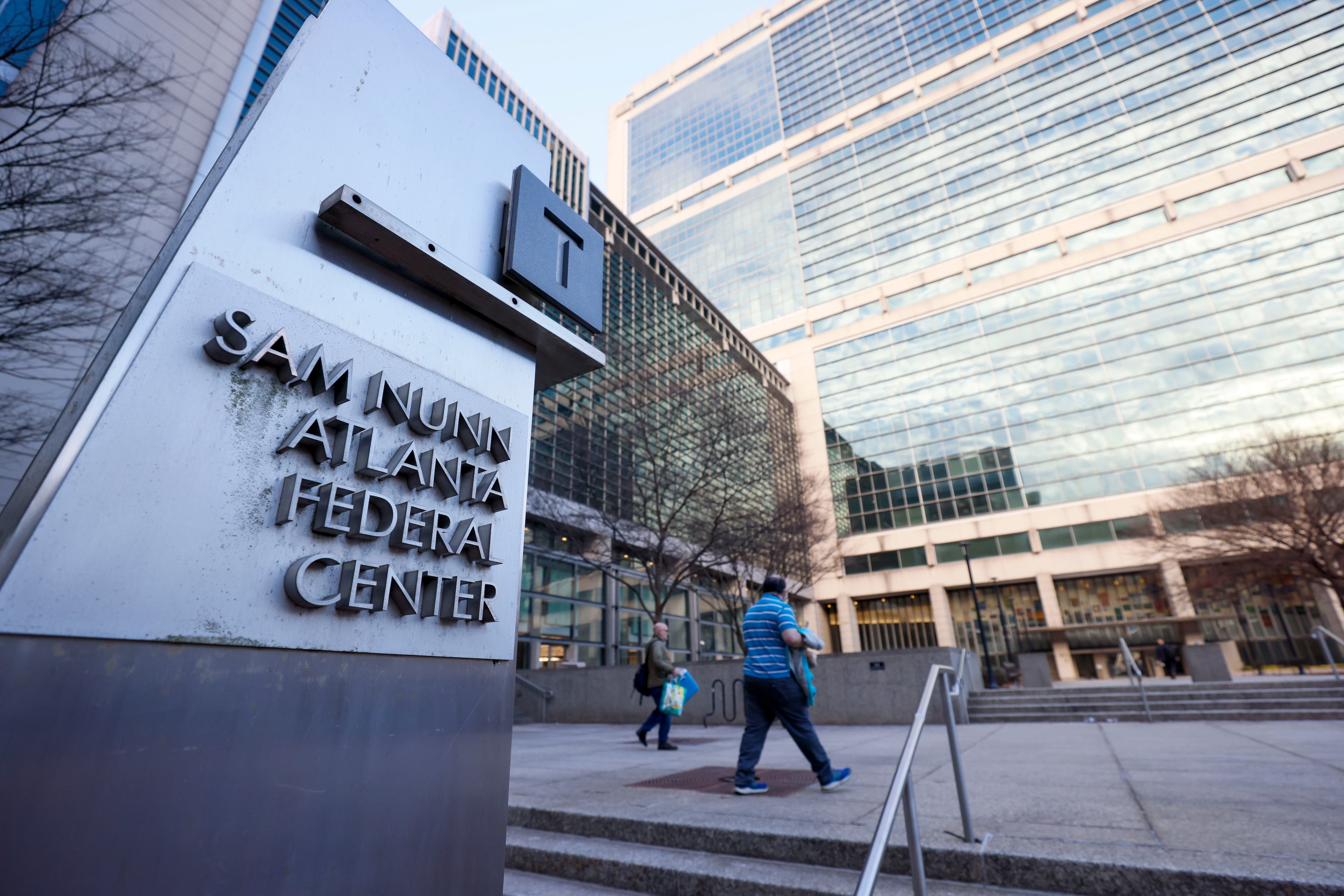 A couple of people are seen headed to the Sam Nunn Atlanta Federal Center on Monday, February 24, 2025. This day marked the first full return-to-office day for numerous federal workers in downtown Atlanta.
(Miguel Martinez/ AJC)