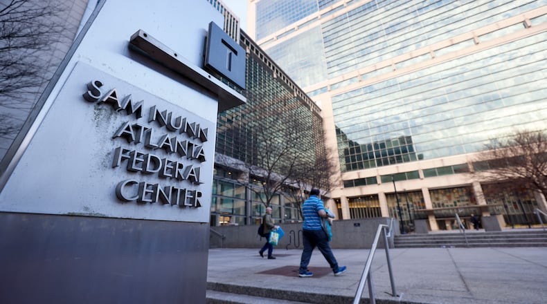 A couple of people are seen headed to the Sam Nunn Atlanta Federal Center on Monday, Feb. 24, 2025. This day marked the first full return-to-office day for numerous federal workers in downtown Atlanta.
(Miguel Martinez/ AJC)