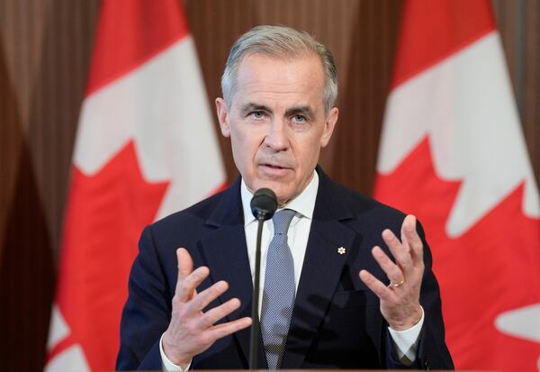 Canada Prime Minister Mark Carney speaks with media on Parliament Hill following a meeting of the Cabinet Committee on Canada-U.S. Relations and National Security, in Ottawa, Thursday, March 27, 2025. (Adrian Wyld/The Canadian Press via AP)