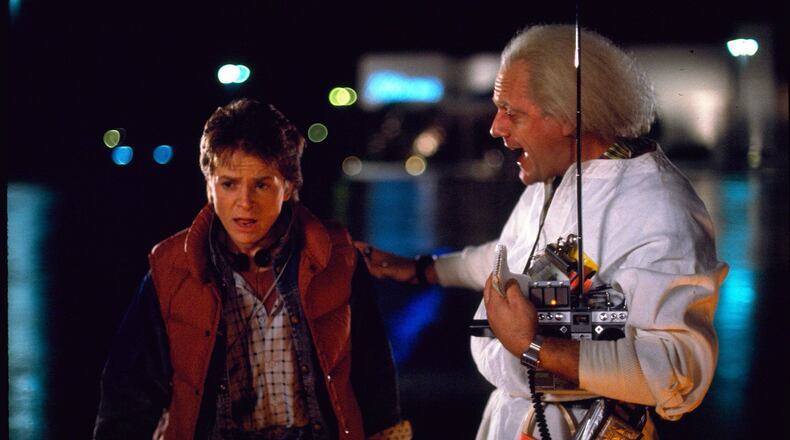 This photo released by Universal Pictures shows, Michael J. Fox, left, as Marty McFly, and Christopher Lloyd as Dr. Emmett Brown, in a scene from the 1985 film, “Back to the Future.” Co-stars Lea Thompson, Lloyd and others gather on Tuesday, June 30, 2015, for a special screening of the 1985 Michael J. Fox time-travel blockbuster, to be presented on the massive Hollywood Bowl screen with musical score performed live and orchestra conducted by the original composer, Alan Silvestri. (Universal Pictures via AP)