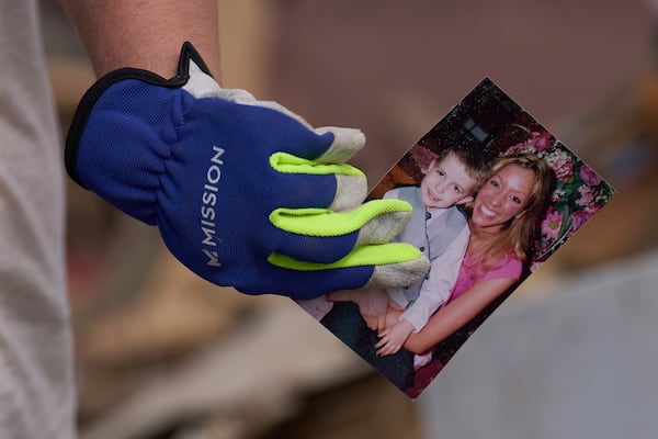Edwina Wilson holds a photo she found in what is left of her destroyed home, Sunday, May 18, 2025, in London, Ky., after a severe storm passed through the area. (AP Photo/Carolyn Kaster)
