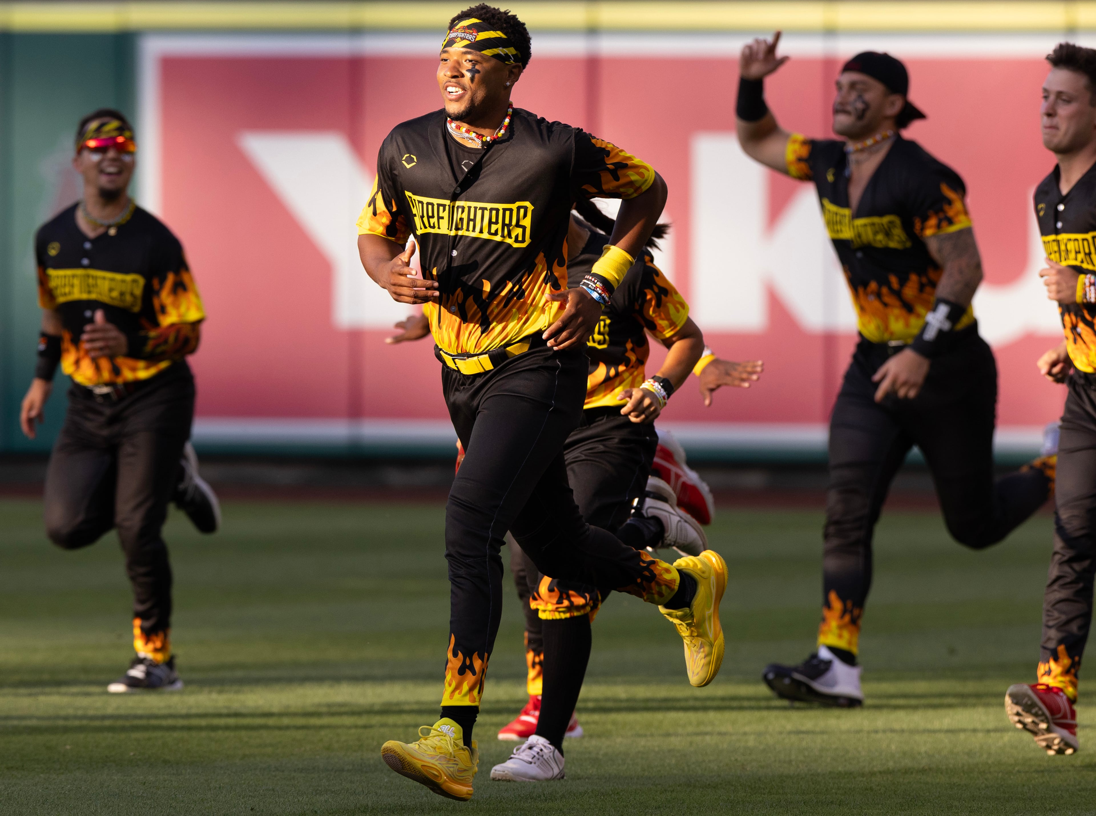 The Firefighters run on the field before taking on the Savannah Bananas at Angel Stadium on Friday, May 30, 2025, in Anaheim, California. (Luke Johnson/Los Angeles Times/TNS)