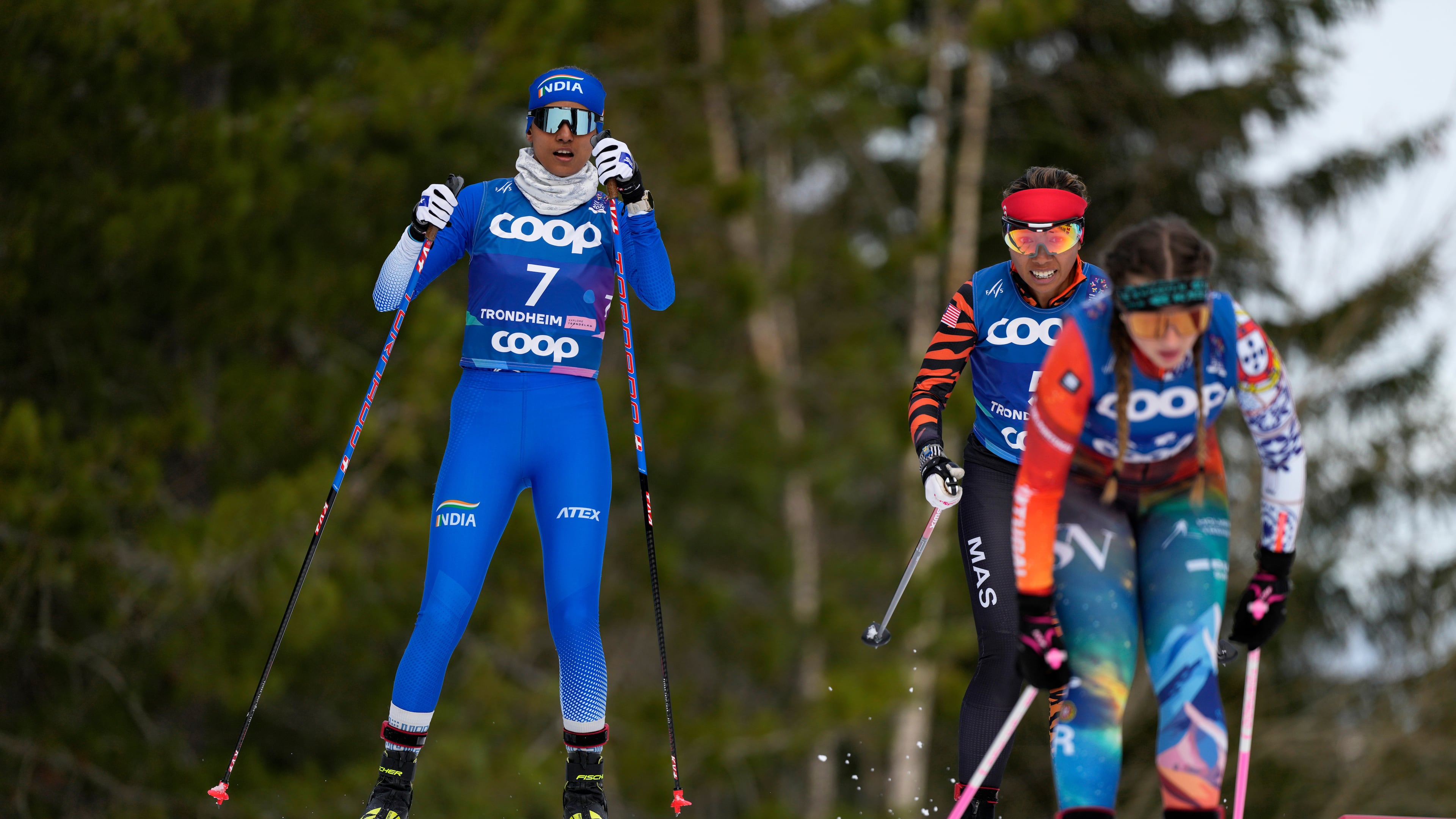 FILE - Bhavani Thekkada Nanjunda, of India, Khadijah Ismail, of Malaysia, and Mariana Cabrita, of Portugal, from left, compete in the cross-country women's 7.5 km Interval Start Classic qualification race at the Nordic World Ski Championships in Trondheim, Norway, Feb. 26, 2025. (AP Photo/Matthias Schrader, File)
