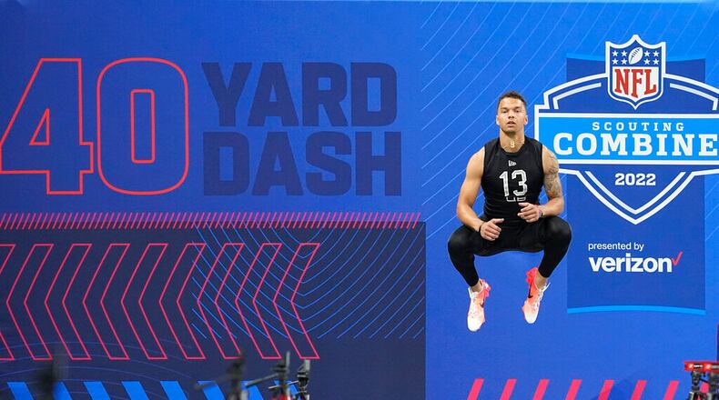 Cincinnati quarterback Desmond Ridder jumps before he runs the 40-yard dash during the NFL football scouting combine, Thursday, March 3, 2022, in Indianapolis. (AP Photo/Darron Cummings)