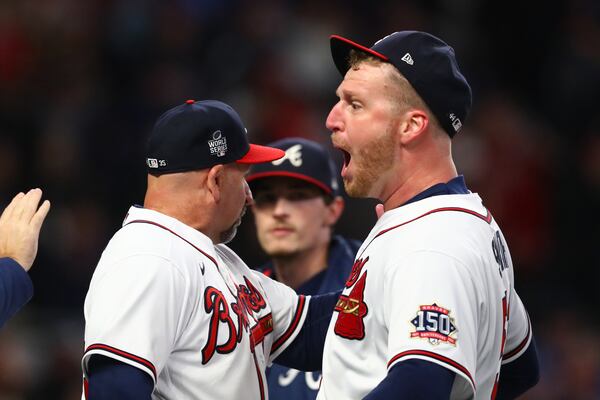 Braves relief pitcher Will Smith, right, celebrates with teammates after their 3-2 win against the Houston Astros in game 4 in the World Series at Truist Park, Saturday October 30, 2021, in Atlanta. Curtis Compton / curtis.compton@ajc.com