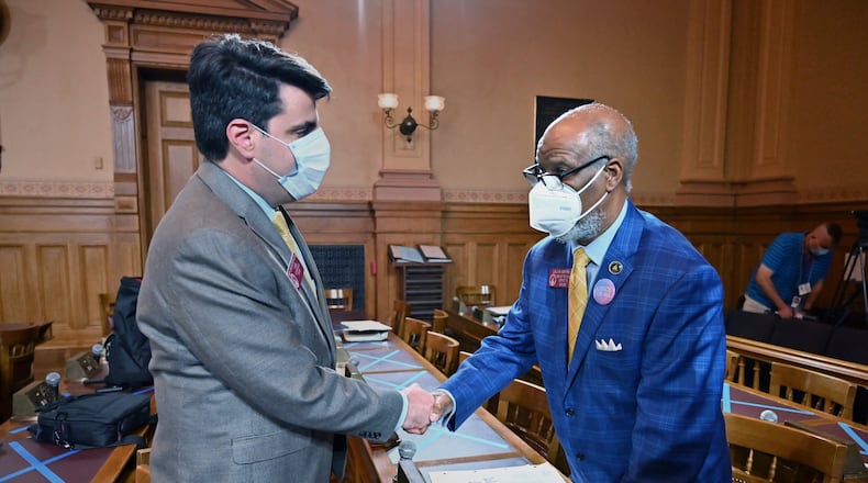 Republican Rep. Chuck Efstration of Dacula, left, and Democratic Rep Calvin Smyre of Columbus shake hands as they wait for a press conference after House Bill 426 passed in the Georgia House on Tuesday. The bill would implement stiffer penalties for those guilty of crimes are found to have been motivated by hate. (Hyosub Shin / Hyosub.Shin@ajc.com)