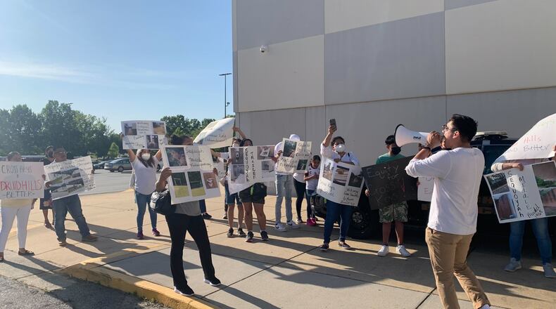 Cross Keys High School students and community members protest deteriorating building conditions at their school and at others in the region outside a DeKalb County Board of Education meeting in Stone Mountain on May 9, 2022. The school district has identified more than 1,000 maintenance problems at its 22 high schools. (Cassidy Alexander/cassidy.alexander@ajc.com)