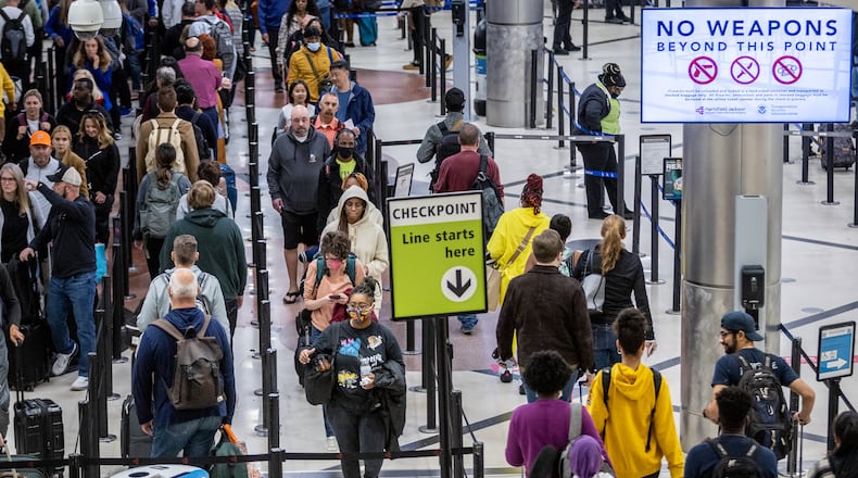 Travelers stand in line to go through the security checkpoint at Hartsfield-Jackson Atlanta International Airport during a busy Friday morning, October 28, 2022. (Steve Schaefer/steve.schaefer@ajc.com)
