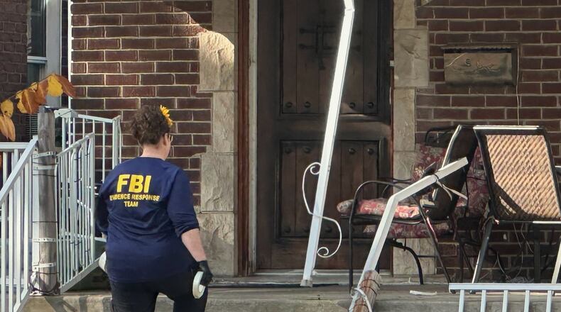 An FBI agent enters a home in a Dearborn, Mich., neighborhood on Friday, Oct. 31, 2025. (AP Photo/Mike Householder)