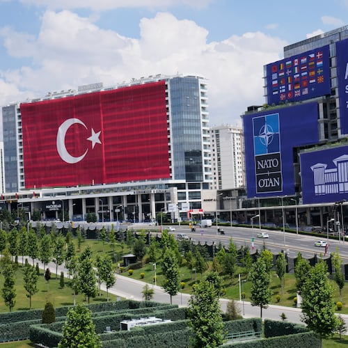A Turkish flag and NATO banners cover buildings ahead of the NATO Summit in Ankara, Turkey, Monday, July 6, 2026. (AP Photo/Hussein Malla)
