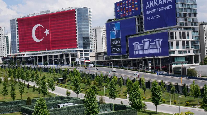 A Turkish flag and NATO banners cover buildings ahead of the NATO Summit in Ankara, Turkey, Monday, July 6, 2026. (AP Photo/Hussein Malla)