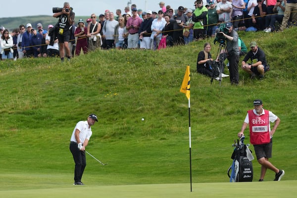 Brian Harman of the United States chips onto the 16th green during the second round of the British Open golf championship at the Royal Portrush Golf Club, Northern Ireland, Friday, July 18, 2025. (AP Photo/Jon Super)