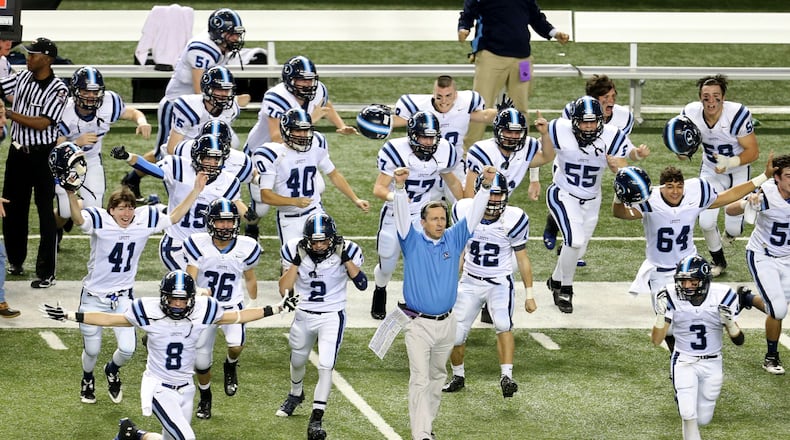 As time expires, Lovett coach Mike Muschamp, center, and players celebrate their 14-7 win over Lamar County at the Georgia Dome in Atlanta on Saturday, December 14, 2013.