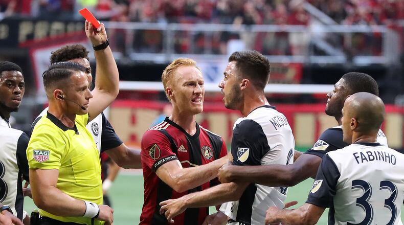 June 2, 2018 Atlanta: An official pulls a red card on Philadelphia Union midfielder Haris Medunjanin as Atlanta United midfielder Jeff Larentowicz holds him back while he argues a call during the first half in a MLS soccer match on Saturday, June 2, 2018, in Atlanta. Two Philadelphia Union players drew red cards on the play and were ejected from the game.  Curtis Compton/ccompton@ajc.com