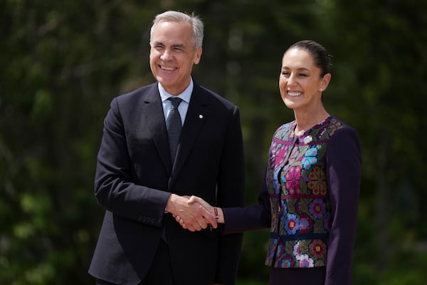 Canada's Prime Minister Mark Carney welcomes Mexican President Claudia Sheinbaum to the G7 Summit in Kananaskis, Alberta, Tuesday, June 17, 2025. (Darryl Dyck/The Canadian Press via AP)