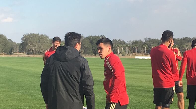 Atlanta United's Ezequiel Barco talks with an assistant coach on Wednesday during training camp in Florida.