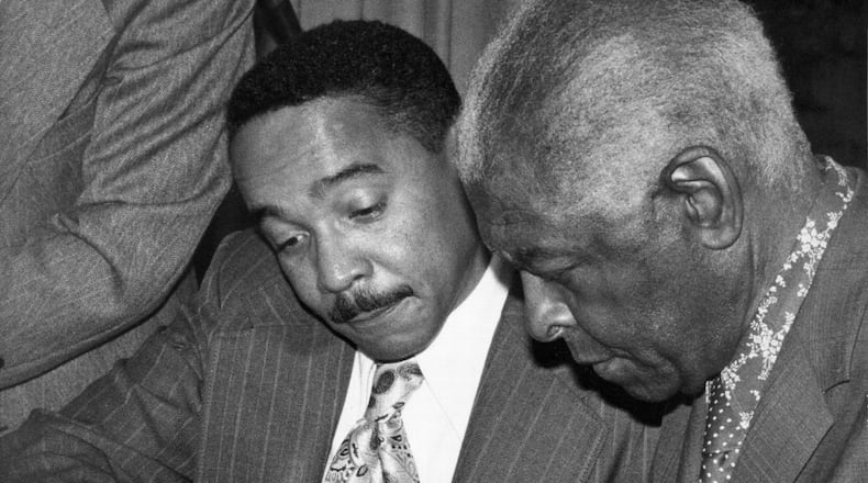 Alonzo Crim (left), former superintendent of Atlanta Public Schools, confers with Dr. Benjamin Mays in this photo taken in the early 1970s. (AJC STAFF / FILE PHOTO)