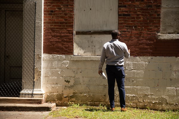 David Bond, an architect with the Fitzgerald Collaborative Group, surveys the state of the Lakewood Elementary School on July 17, 2025 as developers interested in redeveloping the site tour its grounds. (Riley Bunch/AJC)