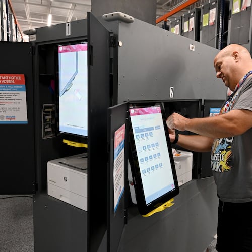 Craig Avena, an election worker, tests a voting touchscreen at the Cobb County Elections & Registration building in Marietta on Tuesday, Sept. 22, 2026. Officials are testing voting touchscreens, ballot scanners and check-in tablets in the run-up to the midterms in an effort to find and mitigate problems before voting starts. (Hyosub Shin/AJC)