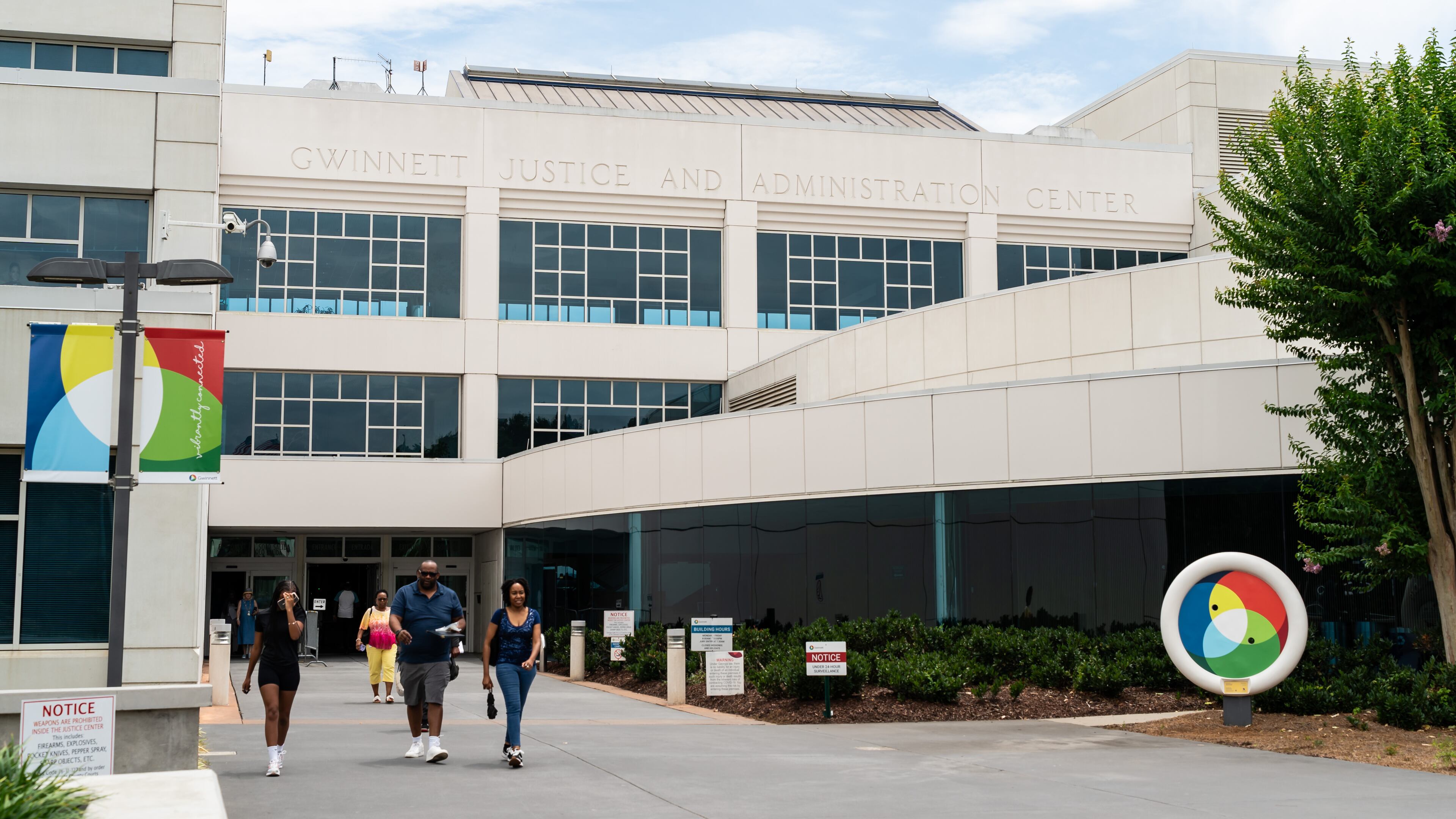 People exit the Gwinnett Justice & Administration Center in Lawrenceville, Georgia, on Friday, July 19, 2024. (Seeger Gray/AJC)