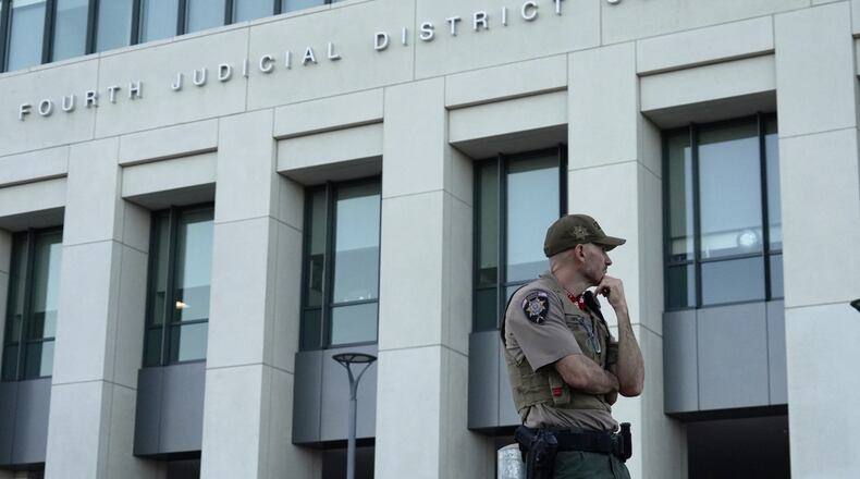 law enforcement monitors the parking lot outside the fourth judicial District courthouse where a preliminary hearing for Tyler Robinson, the Utah man accused of fatally shooting Charlie Kirk, in Provo, Utah, Friday, July 10, 2026. (AP Photo/Ty ONeil)