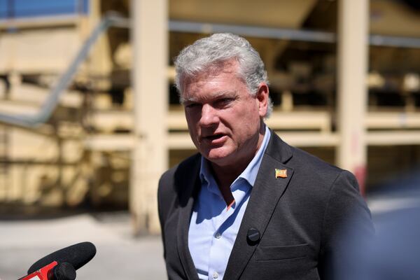 U.S. Rep. Mike Collins speaks with reporters at an asphalt plant in Norcross on Tuesday. (Jason Getz/AJC)