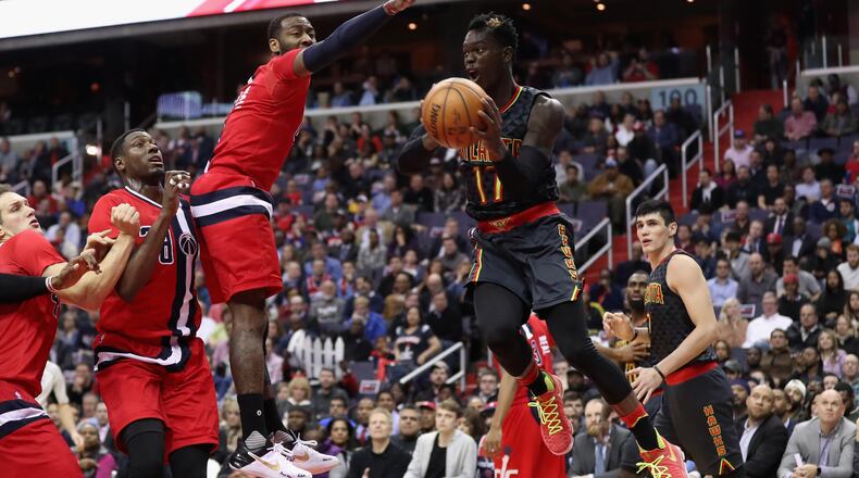 Dennis Schroder of the Atlanta Hawks looks to pass around John Wall of the Washington Wizards at Verizon Center on March 22, 2017 in Washington, DC. (Photo by Rob Carr/Getty Images)