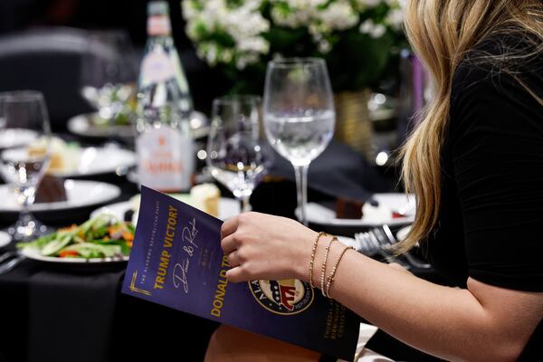 A guest looks over the program for Donald Trump Jr.'s visit to speak at the Alabama Republican Party's Trump Victory Celebration, Thursday, April 3, 2025, in Birmingham, Ala. (AP Photo/Butch Dill)