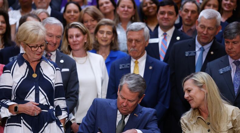 Gov. Brian Kemp signs a series of education bills at the Capitol in Atlanta on May 5, 2026, including a school literacy bill. The bill provides training and support for educators, requires screening for dyslexia and other learning disabilities and mandates kindergarten attendance. (Arvin Temkar/AJC)